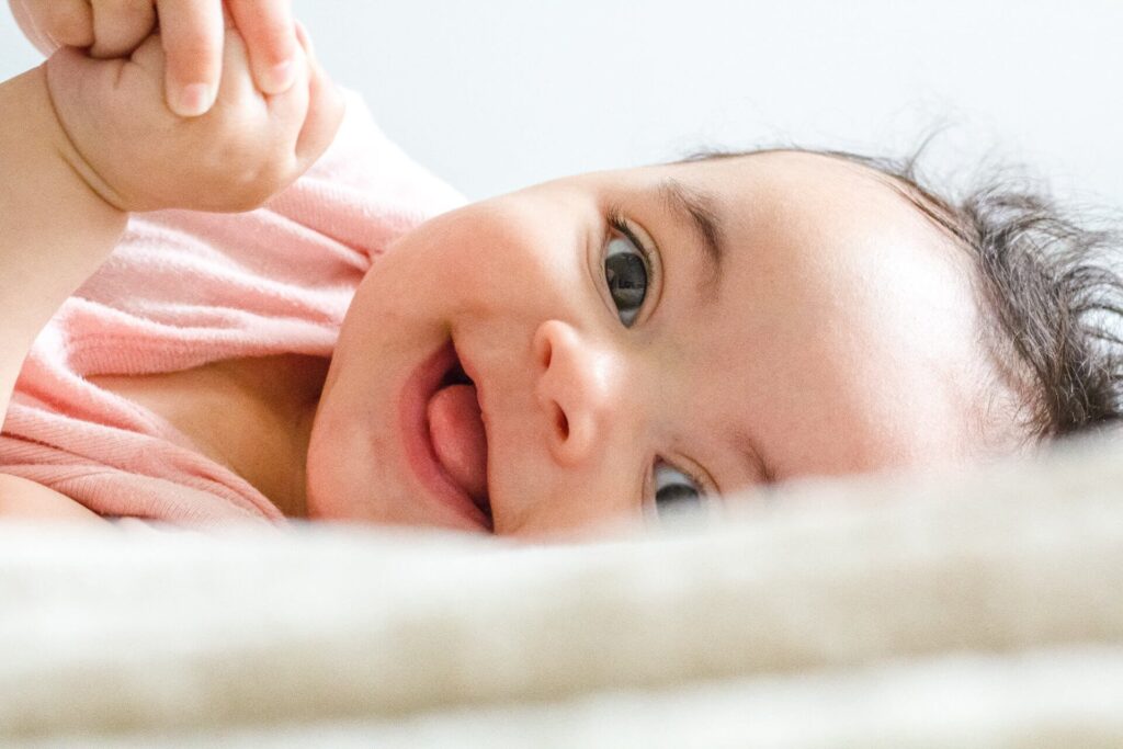 smiling baby at a naming ceremony